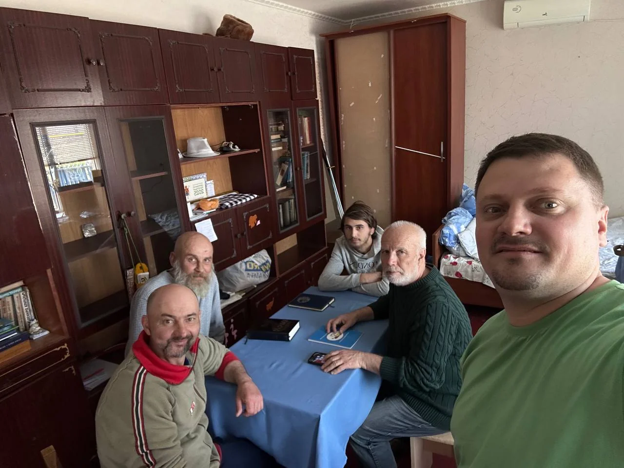People together around a table during a group meeting