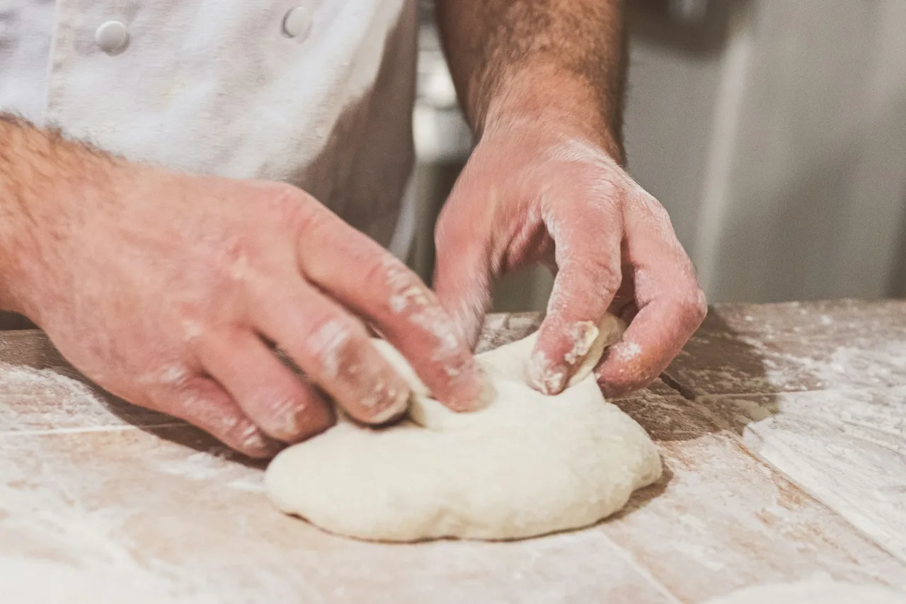 Hands kneading bread dough