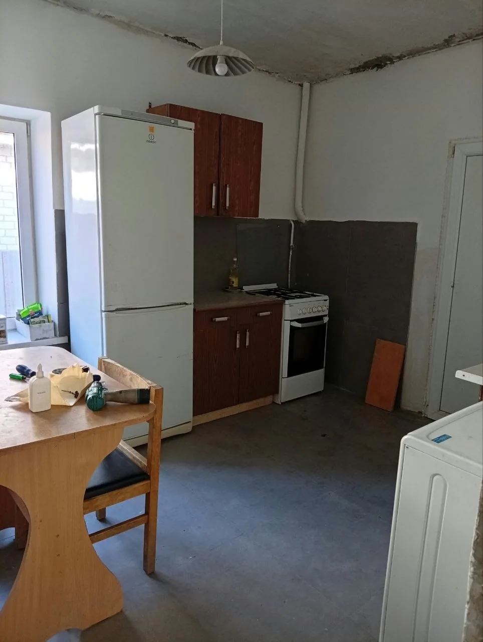 Kitchen with cabinets, refrigerator, sink and table in October 2026