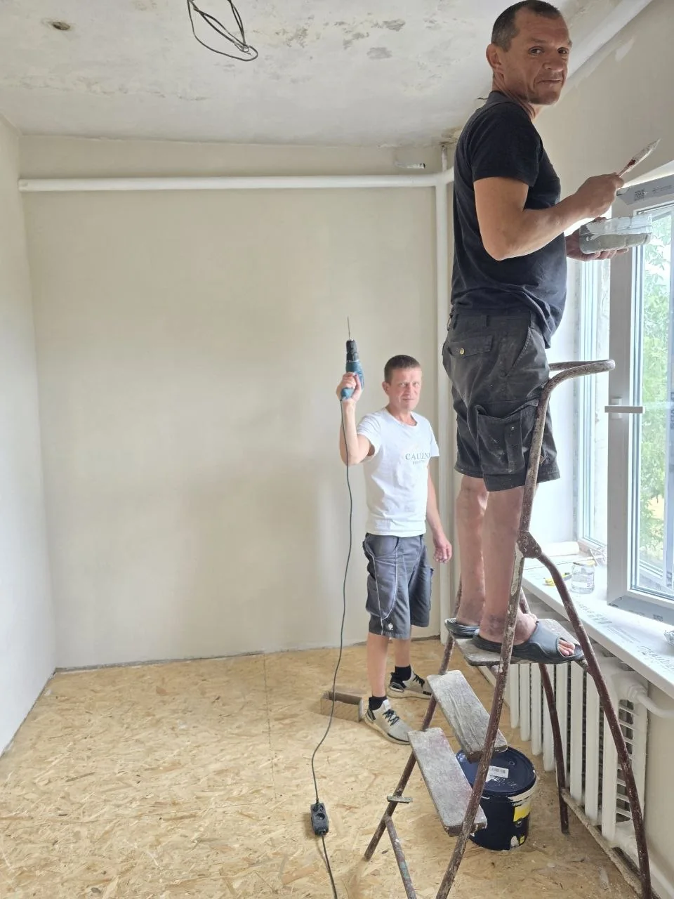 People working together to prepare a room